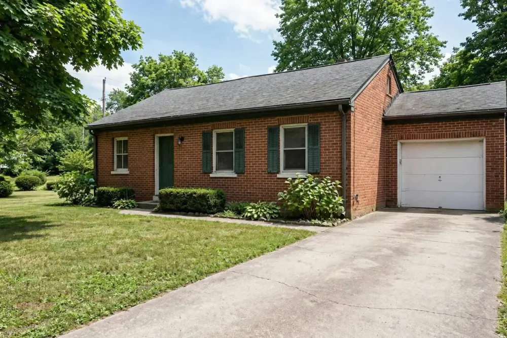 Brick ranch house with a neat lawn and driveway